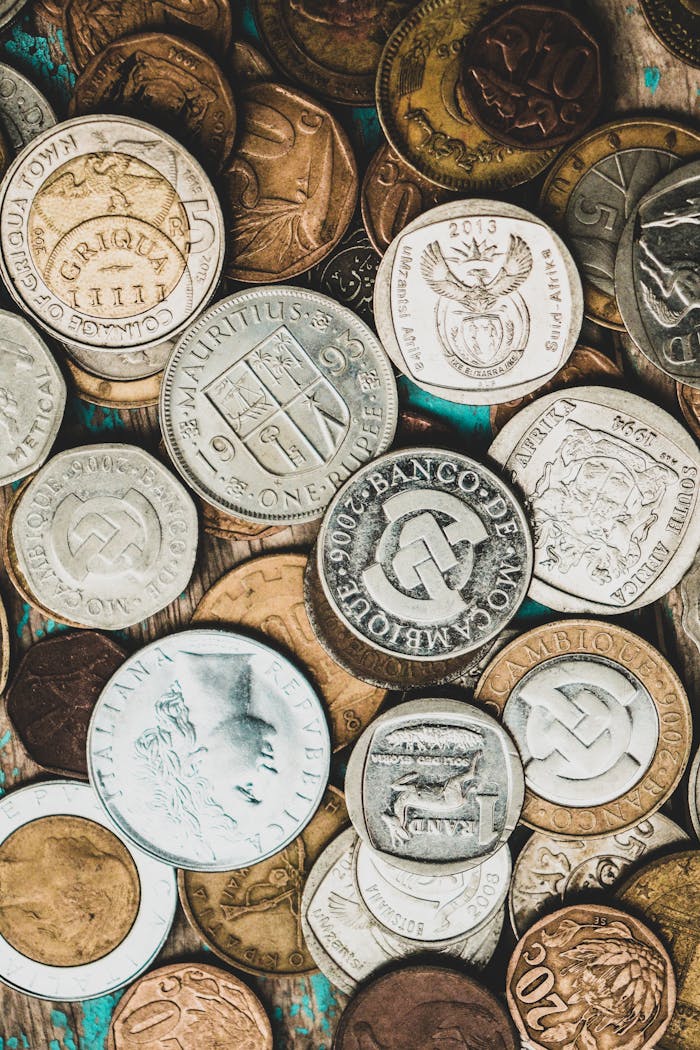 A detailed close-up of a collection of international coins showcasing various currencies.